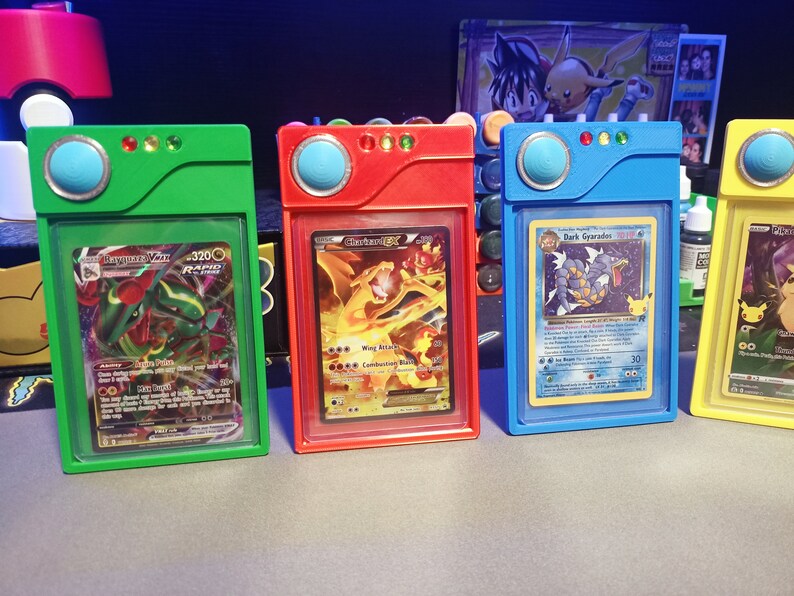 May include: Four colorful plastic card holders with different Pokemon cards inside. The holders are green, red, blue, and yellow. The cards are "Sceptile-EX", "Charizard-EX", "Dark Gyrados", and "Mewtwo-EX".