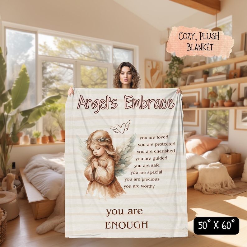 May include: A white plush blanket with the words "Angel's Embrace" and a quote about being loved, protected, cherished, guided, safe, special, precious, and worthy. The blanket also features a watercolor illustration of an angel with wings and a heart. The blanket is 50 inches by 60 inches.
