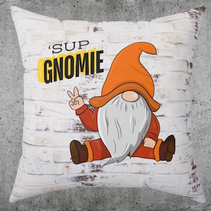 May include: White pillow with a gnome graphic and the text 'Sup Gnomie'. The gnome is wearing a red and orange hat and has a white beard.