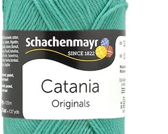 May include: A skein of teal blue Catania Originals yarn by Schachenmayr. The yarn is 100% cotton and is made in Germany. The label says "Catania Originals" and "Schachenmayr Since 1822".