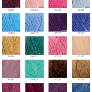 May include: A color chart of 16 different shades of yarn. The yarn is a soft, fuzzy texture. The colors include red, pink, blue, green, brown, and purple.