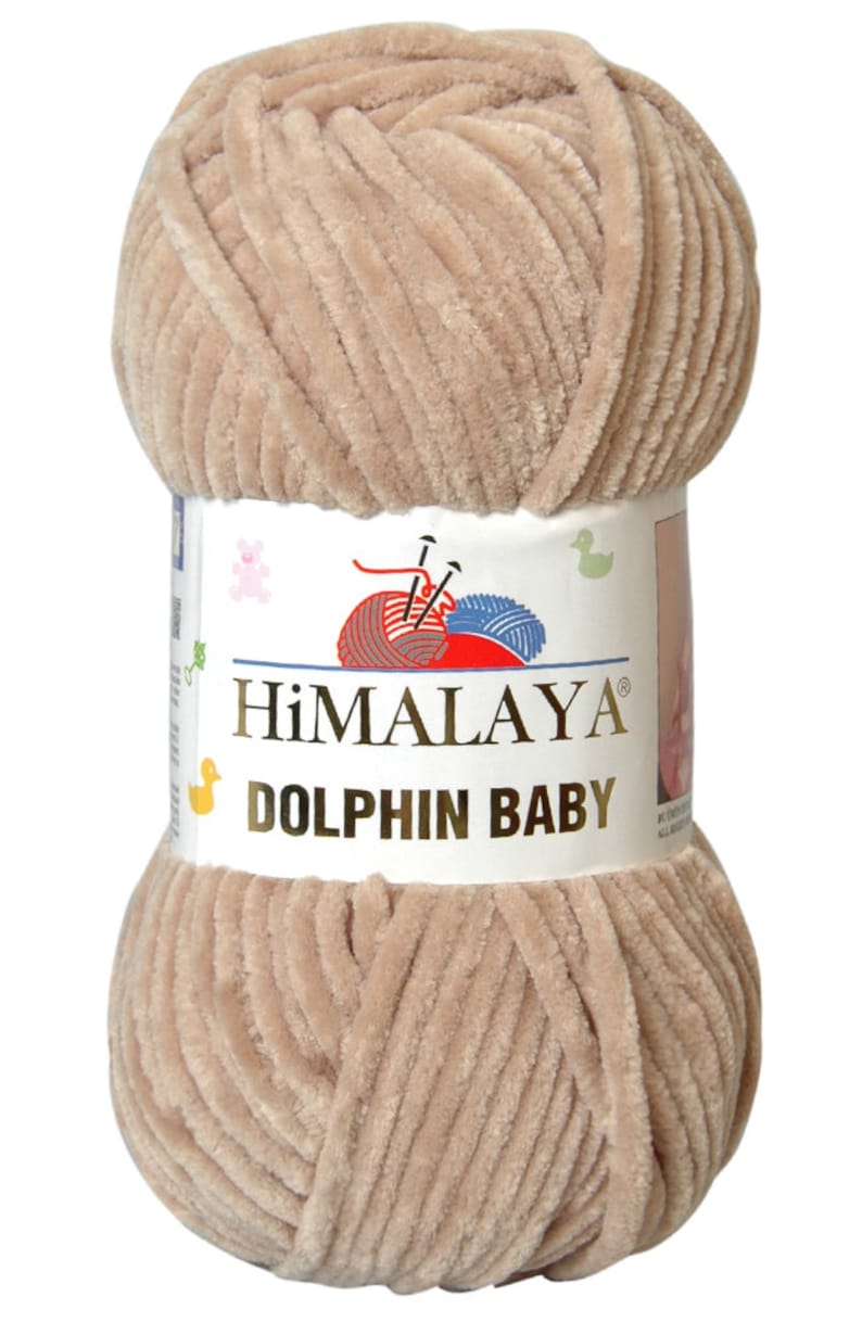 May include: A skein of beige Himalaya Dolphin Baby yarn. The yarn is soft and fluffy, perfect for knitting or crocheting baby blankets, sweaters, and other items.