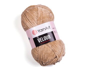 May include: A skein of beige velour yarn with the label "YarnArt Velour" and the website address "www.yarnart.info".