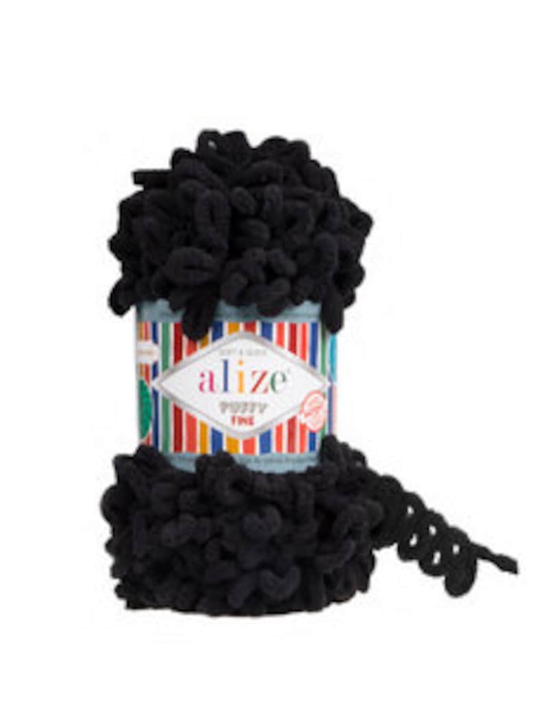 May include: A skein of black Alize Puffy Fine yarn. The yarn is a soft, fluffy texture and is perfect for crocheting or knitting.