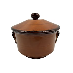 May include: A brown ceramic covered dish with two handles and a knob on the lid.