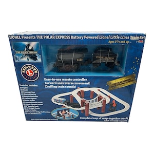 May include: A boxed Lionel Polar Express battery-powered train set. The set includes an engine, tender, passenger cars, and track. The box features the Polar Express logo and text, with a picture of the train and track layout. Ages 2 1/2 and up.