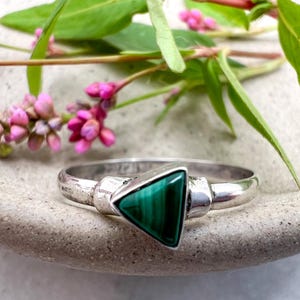 May include: A set of three ceramic mugs with a speckled, matte finish. The mugs are in shades of cream, light gray, and dark gray. Each mug has a simple, minimalist design, perfect for coffee or tea.