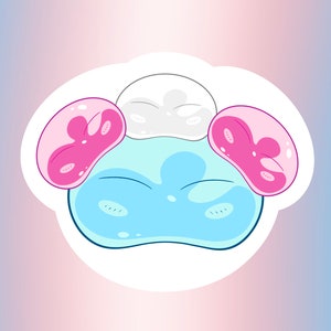 May include: A cartoon sticker of a blue, pink, and white blob with a smiling face. The blob has two pink ears and a white head.