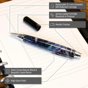 May include: A black and silver pen with a purple, blue, and green marbled design. The pen has a spring-loaded cartridge and a high gloss finish. It is made from hand-turned natural wood and beautiful casted resins.