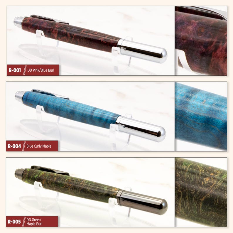 May include: Three wooden pens with different colored wood grain patterns. The pens are on a white surface with a clear stand. The pens are labeled R-001 DD Pink/Blue Burl, R-004 Blue Curly Maple, and R-005 DD Green Maple Burl.