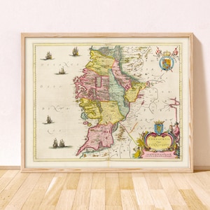 May include: A framed antique-style map of Connacht, Ireland, featuring hand-coloured regions in pink, yellow, and green. The map includes illustrations of sailing ships in the ocean, a decorative crest, and a cartouche labelled Connachtia.