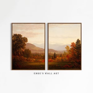 May include: A pair of framed landscape paintings depicting a rural scene with rolling hills, trees, and a distant town. The paintings are in a warm, autumnal color palette with shades of brown, orange, and yellow.