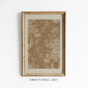 May include: A framed print with a beige floral design on a brown backdrop. The artwork is set within a gold-coloured frame and a beige mount. The text "EMRE'S WALL ART" is printed at the bottom of the image.