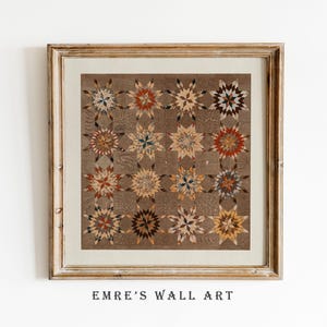 May include: A framed wall art print featuring a detailed quilt pattern with star-shaped designs in shades of brown, beige, and red. The artwork is set against a textured background and framed in a distressed gold-colored frame. The text "EMRE'S WALL ART" is at the bottom.