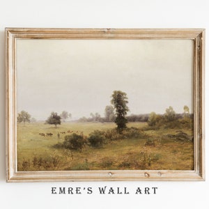 May include: A framed painting depicting a rural landscape with a field, trees, and a group of cows in the distance. The sky is a soft, muted gray, and the overall tone of the painting is peaceful and serene.
