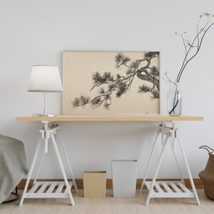 A vintage Japanese ink wash painting of a pine tree branch with detailed pine needles and a small pinecone against a textured beige paper background. The elegant black brushstrokes capture a minimalist, traditional East Asian artistic look. A small red artist seal is visible in the bottom right corner.