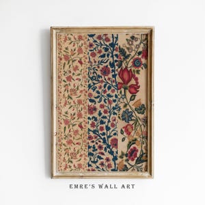 May include: A framed print of a vintage floral pattern in shades of red, blue, and cream. The pattern is made up of repeating floral motifs and is set against a cream background. The frame is a simple, light wood frame.