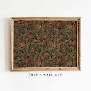 May include: A framed floral print with a dark background and a repeating pattern of red and green flowers and leaves. The frame is a light brown color. The text "EMRE'S WALL ART" is printed at the bottom.