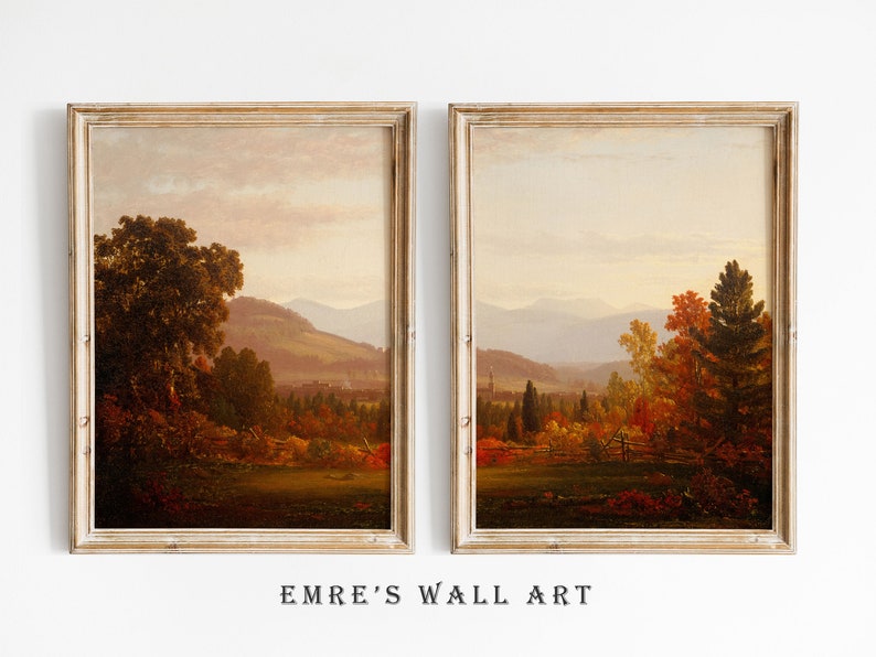 May include: Two framed landscape paintings depicting autumn scenes with rolling hills, trees, and a distant town. The paintings are in a rustic style with warm colors.