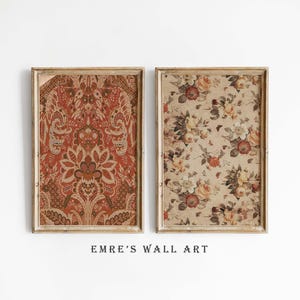 May include: Two framed wall art prints. The left print has a detailed, ornate pattern in red, brown, and beige. The right print shows a floral design with cream, yellow, and red roses. The frames are light brown. The text "EMRE'S WALL ART" is at the bottom of the image.