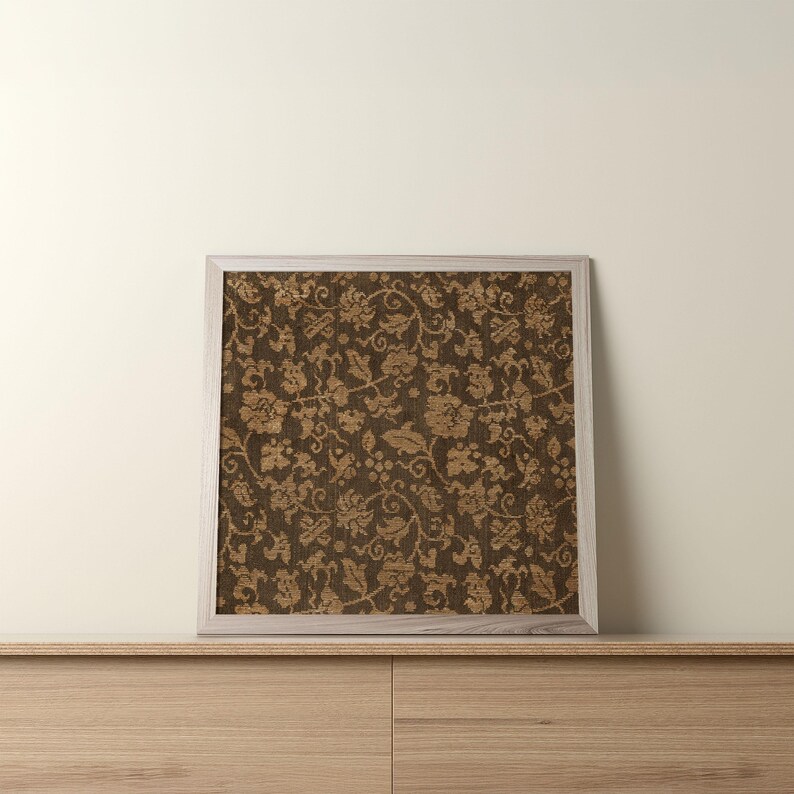 An antique-style botanical fabric art print featuring an intricate rustic textile pattern in warm brown tones. The design shows woven floral vines and leaves, arranged in an old-world tapestry style. The soft contrast between background and pattern gives a sense of depth and age. Ideal for vintage-inspired digital wall decor and home styling.