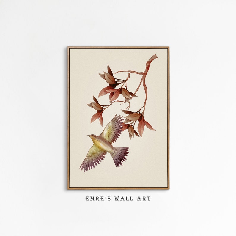 May include: A watercolor painting of a bird in flight with brown and yellow feathers, against a background of a branch with red leaves. The painting is framed in a light wood frame.