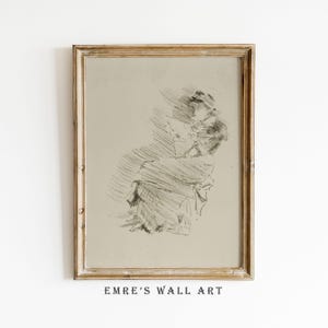 Könnte beinhalten: Eine gerahmte Skizze im Vintage-Stil einer Person, die in Grau- und Schwarztönen gehalten ist. Das Kunstwerk befindet sich in einem goldfarbenen Rahmen. Der Text "EMRE'S WALL ART" ist unten im Rahmen in Schwarz gedruckt.
