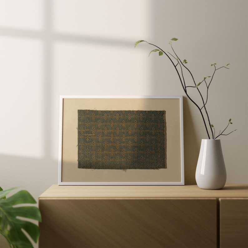 Digital print of a green textile pattern with gold geometric motifs, antique fabric wall art reproduction, textured tapestry design in muted tones.