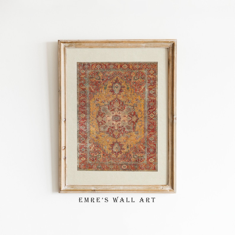 May include: A framed print of a vintage rug with a red, gold and blue pattern. The frame is a light wood colour. The text "EMRE'S WALL ART" is below the frame.