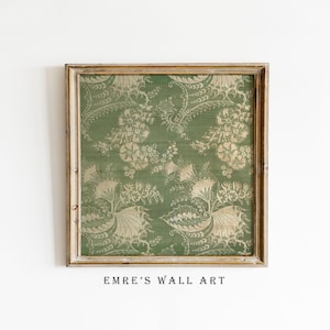 May include: Square framed wall art featuring a green background with a repeating floral pattern in a lighter shade of green. The frame is a light brown color. The text "EMRE'S WALL ART" is printed at the bottom of the image.