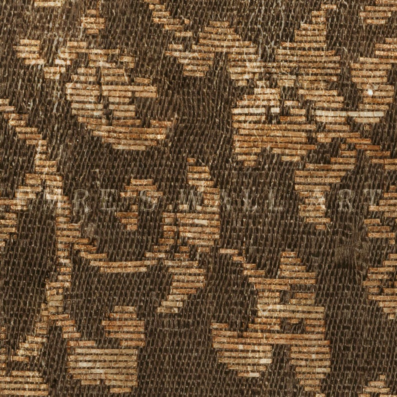 May include: Close-up of a woven fabric with a repeating pattern in shades of brown and tan. The design features stylized floral or geometric shapes, creating a textured surface. The fabric appears to be vintage or antique.