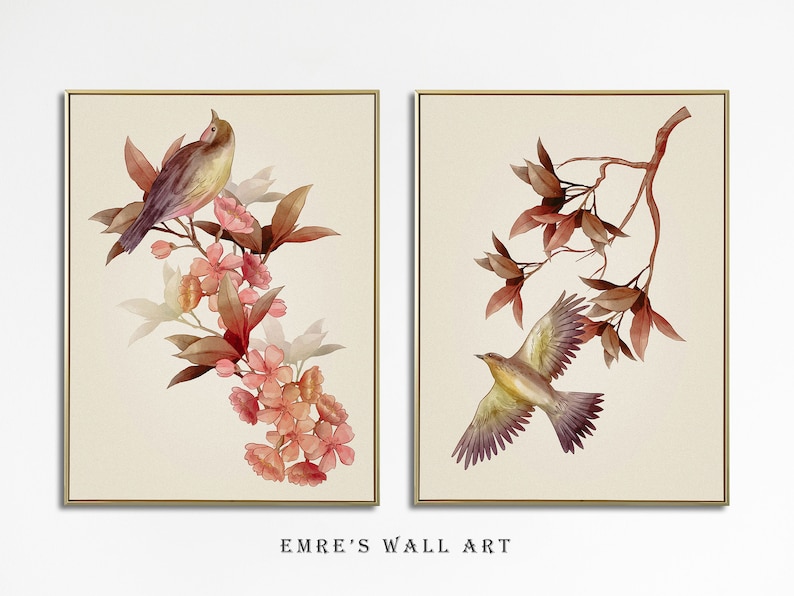 May include: Two framed watercolor paintings with a bird and floral motif. The first painting features a brown and yellow bird perched on a branch with pink flowers. The second painting features a brown and yellow bird in flight with brown leaves.