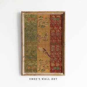 May include: Framed wall art with a vintage textile design. The artwork is divided into vertical panels of green, gold, and red, each with intricate patterns of flowers, birds, and foliage. The frame is a light brown colour. The text "EMRE'S WALL ART" is at the bottom.