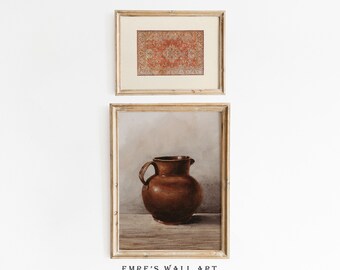 May include: Two framed prints on a white wall. The top print features a red and orange patterned rug. The bottom print features a brown ceramic pitcher on a wooden table.