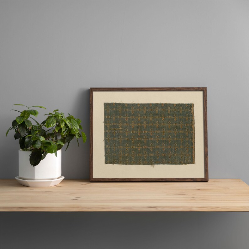 Old green fabric swatch with delicate golden motif grid, antique textile pattern artwork, vintage-inspired fabric print for wall art and poster designs.