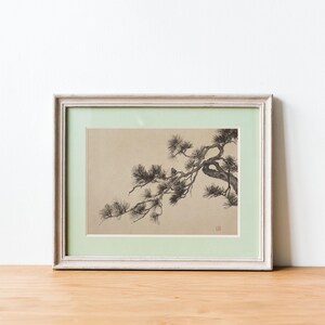 A vintage Japanese ink wash painting of a pine tree branch with detailed pine needles and a small pinecone against a textured beige paper background. The elegant black brushstrokes capture a minimalist, traditional East Asian artistic look. A small red artist seal is visible in the bottom right corner.