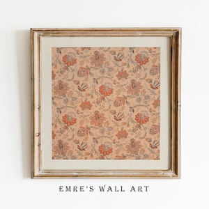May include: Framed wall art featuring a repeating floral pattern in shades of orange, red, and gray on a beige background. The artwork is enclosed in a gold-toned wooden frame. The text "EMRE'S WALL ART" is printed at the bottom.
