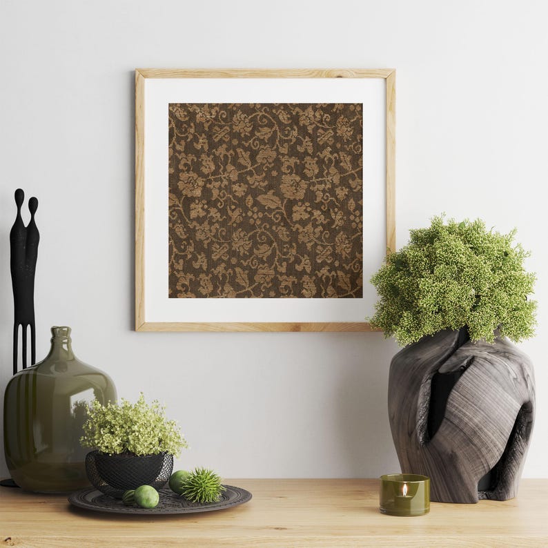 An antique-style botanical fabric art print featuring an intricate rustic textile pattern in warm brown tones. The design shows woven floral vines and leaves, arranged in an old-world tapestry style. The soft contrast between background and pattern gives a sense of depth and age. Ideal for vintage-inspired digital wall decor and home styling.