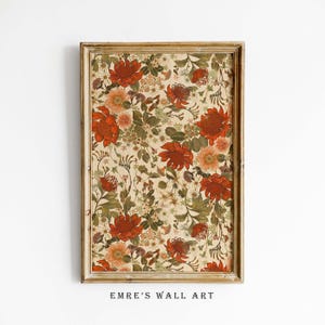 May include: A framed floral print featuring a repeating pattern of red, orange, and green flowers on a cream background. The artwork is in a gold-colored wooden frame. The text "EMRE'S WALL ART" is at the bottom of the frame.