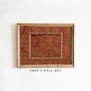 May include: A framed piece of wall art with a red and gold patterned design. The artwork is encased in a wooden frame with a lighter, natural wood finish. The text "EMRE'S WALL ART" is printed at the bottom.