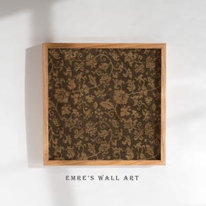 An antique-style botanical fabric art print featuring an intricate rustic textile pattern in warm brown tones. The design shows woven floral vines and leaves, arranged in an old-world tapestry style. The soft contrast between background and pattern gives a sense of depth and age. Ideal for vintage-inspired digital wall decor and home styling.