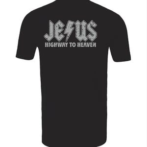 May include: Black t-shirt with the word "JESUS" in a distressed, gray, rock-and-roll style font, with a lightning bolt graphic. Below the word "JESUS" is the phrase "HIGHWAY TO HEAVEN" in a smaller, gray font.