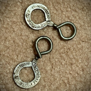 May include: Two silver metal keychains with the text "GREEN STAMPS ALWAYS" and "GREEN STAMPS ALWAYS" on them.