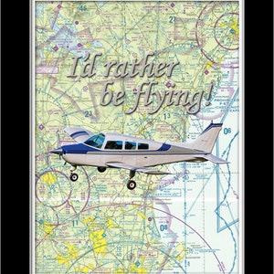 May include: A white and blue airplane with the text "I'd rather be flying!" superimposed on a sectional aeronautical chart. The chart shows the airspace around Boston, Massachusetts.