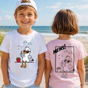 Könnte beinhalten: Ein weißes T-Shirt mit einer Comic-Möwe mit Sonnenbrille und Pommes frites sowie ein hellrosa T-Shirt mit einer schwarzen Grafik derselben Möwe und dem Text MEINS! innerhalb eines rechteckigen Rahmens.