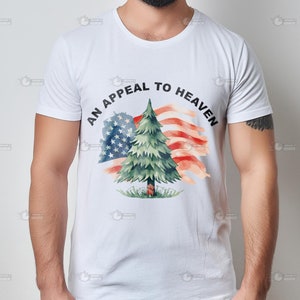 May include: White t-shirt with a watercolor design of a pine tree in front of an American flag. The text "An Appeal to Heaven" is printed in black around the design.