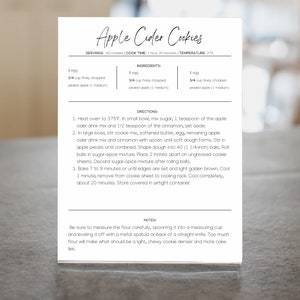 May include: A printable recipe card for Apple Cider Cookies. The recipe card has a white background with black text. The ingredients and directions are listed on the card. The recipe calls for 1 egg, 3/4 cup finely chopped packed apples, and 3/4 cup finely chopped packed apples.