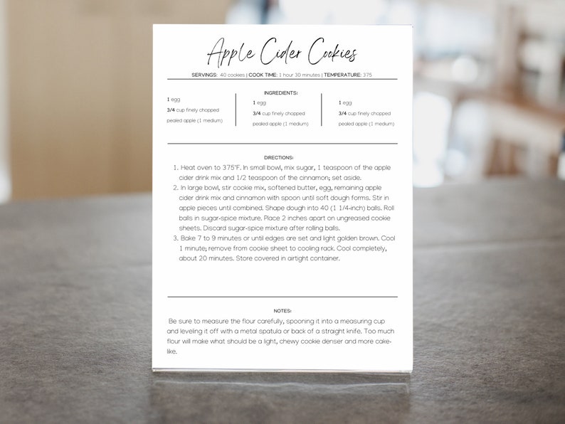 May include: A printable recipe card for Apple Cider Cookies. The recipe card has a white background with black text. The ingredients and directions are listed on the card. The recipe calls for 1 egg, 3/4 cup finely chopped packed apples, and 3/4 cup finely chopped packed apples.