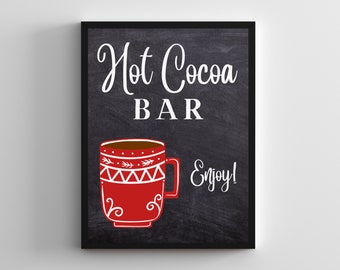 May include: Black chalkboard sign with white text that reads "Hot Cocoa Bar" and a red mug with white designs. The text "Enjoy!" is written in white below the mug.