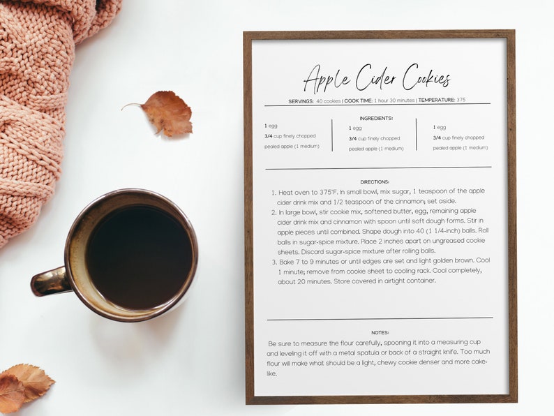May include: A printable recipe card for Apple Cider Cookies. The recipe card includes ingredients, directions, and notes for making the cookies. The recipe card is printed on white paper with black text and is framed in a brown wood frame.